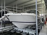 The Image of 2023 Regal 36 Grande Coupe in a covered marina, showcasing sleek design and modern features. - 1