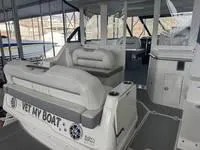 Slide: The Image of 2023 Regal 36 Grande Coupe interior with helm, seating, and docked view. - 12