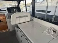 Slide: The Image of 2023 Regal 36 Grande Coupe interior with sleek white cabinetry and seating. - 13