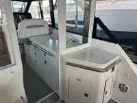 Slide: The Image of 2023 Regal 36 Grande Coupe interior with white leather seating and modern design. - 14