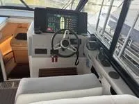 Slide: The Image of 2023 Regal 36 Grande Coupe helm with modern controls and navigation display. - 20