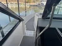 Slide: The Image of Interior view of 2023 Regal 36 Grande Coupe yacht at a marina. - 22