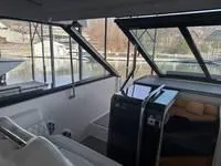 Slide: The Image of 2023 Regal 36 Grande Coupe interior with dashboard and cabin view at marina. - 23