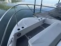 Slide: The Image of 2023 Regal 36 Grande Coupe boat interior with cushioned seating and cup holders. - 25