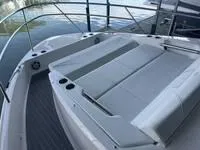 Slide: The Image of 2023 Regal 36 Grande Coupe boat with sleek white seating and modern design. - 26