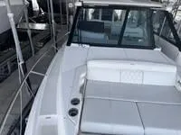 Slide: The Image of 2023 Regal 36 Grande Coupe boat seating area with cup holders and sleek design. - 28