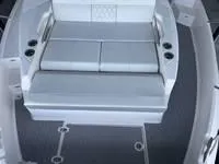 Slide: The Image of 2023 Regal 36 Grande Coupe cabin interior with bed, drawers, and soft lighting. - 30