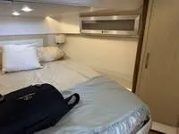 Slide: The Image of 2023 Regal 36 Grande Coupe interior cabin with modern white seating and wood flooring. - 35