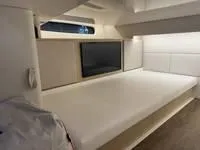 Slide: The Image of 2023 Regal 36 Grande Coupe bathroom interior with modern design and wooden accents. - 37