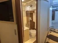 Slide: The Image of 2023 Regal 36 Grande Coupe bathroom with modern sink and wooden cabinetry. - 40