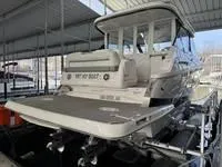 Slide: The Image of 2023 Regal 36 Grande Coupe docked, rear view with seating and "Vet My Boat" text. - 5