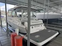 Slide: The Image of 2023 Regal 36 Grande Coupe docked in a marina, rear view with covered seating. - 8