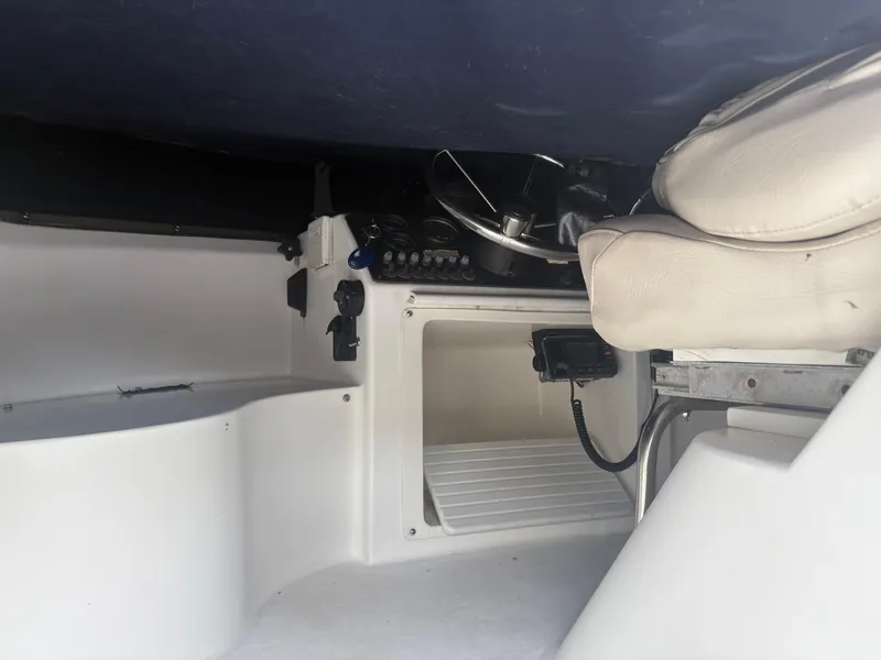 Slide: The Image of Interior of 1998 Penn Yan 269 Legend boat with steering wheel and seating. - 10