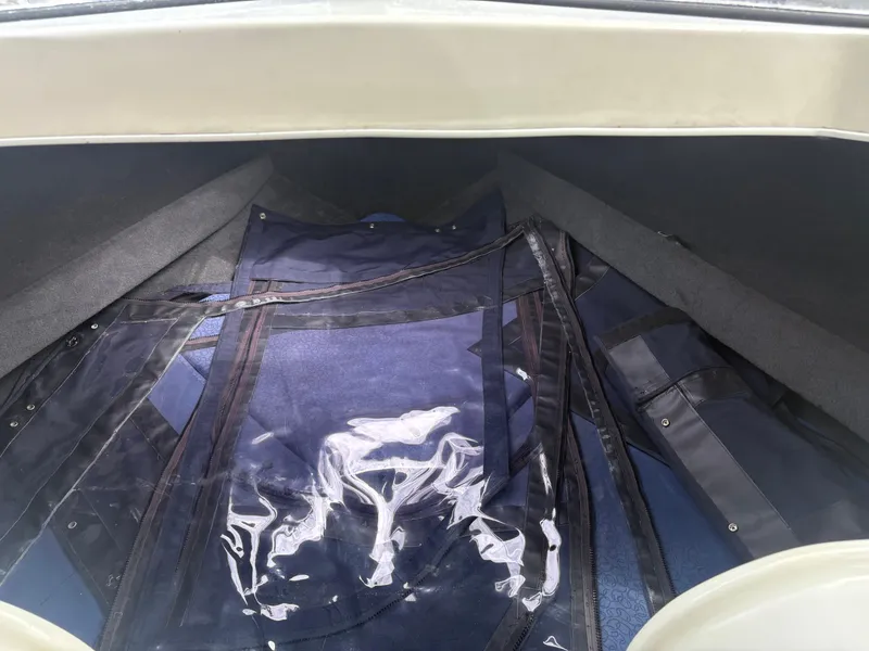 Slide: The Image of Interior view of a 1998 Penn Yan 269 Legend boat with blue and clear coverings. - 13