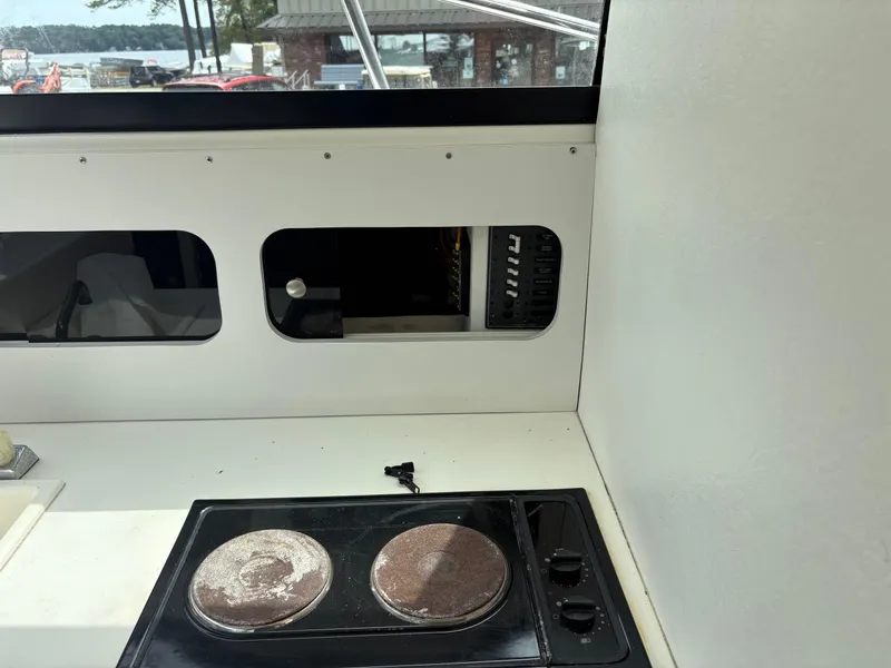 Slide: The Image of Interior of a 1998 Penn Yan 269 Legend boat with a built-in stove. - 15