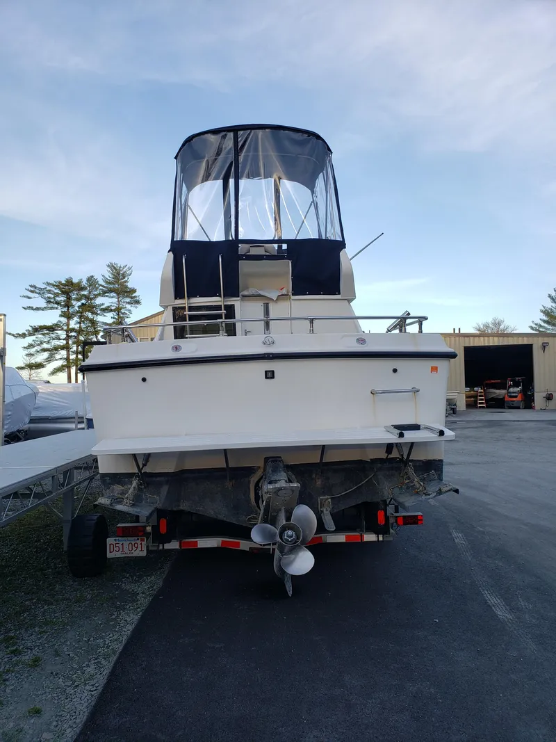 Slide: The Image of 1998 Penn Yan 269 Legend boat on trailer, rear view, outdoor setting. - 18
