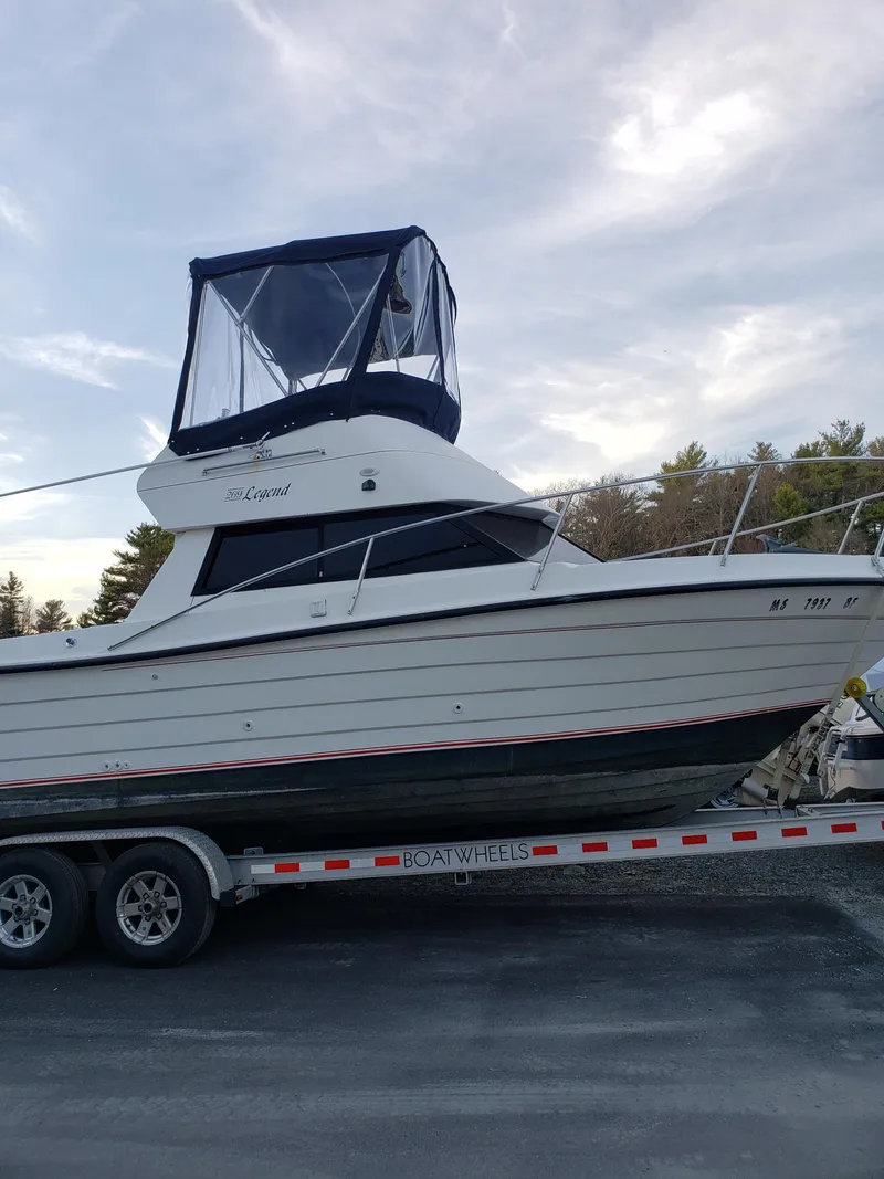 Slide: The Image of 1998 Penn Yan 269 Legend boat on trailer under a cloudy sky. - 21