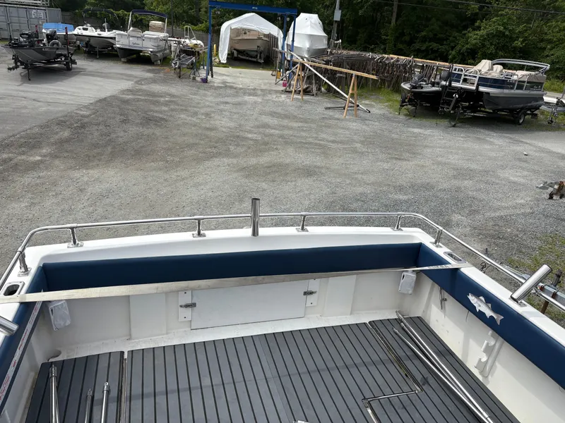 Slide: The Image of 1998 Penn Yan 269 Legend boat in a storage yard with other boats. - 7