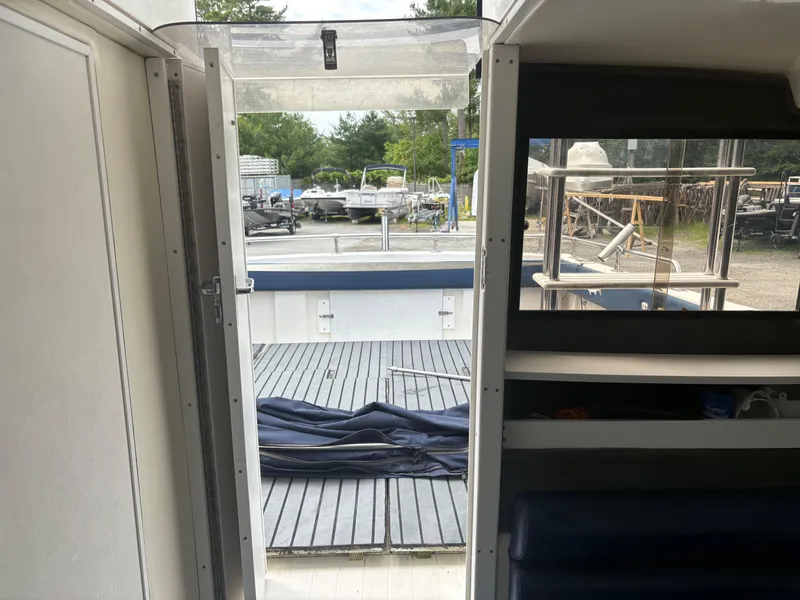 Slide: The Image of Interior view of a 1998 Penn Yan 269 Legend boat, showing the deck and open door. - 8