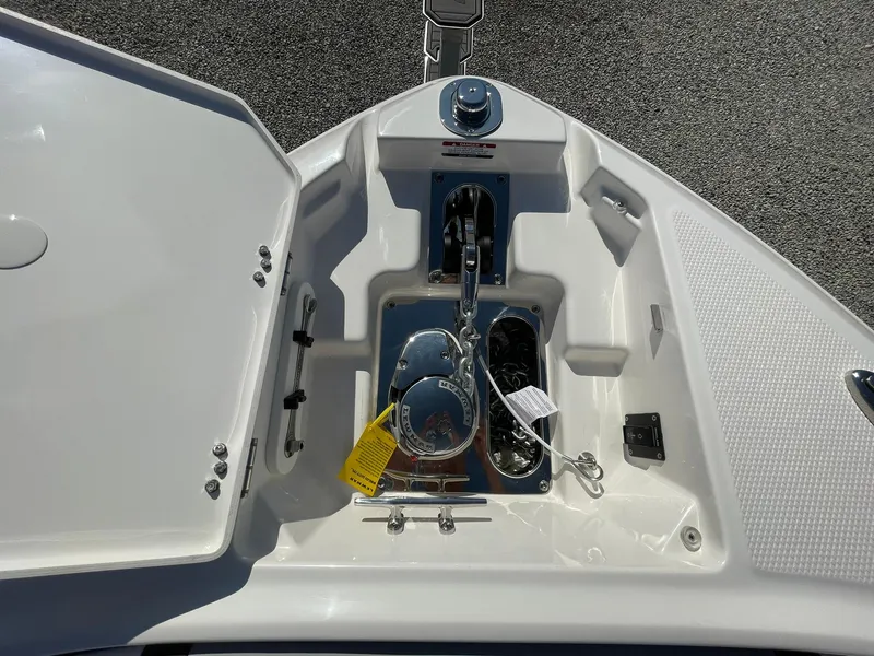 Slide: The Image of Anchor compartment of 2025 Chaparral 270 OSX boat, featuring storage and winch. - 7