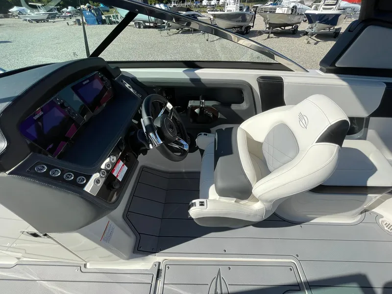 Slide: The Image of 2025 Chaparral 270 OSX boat cockpit with modern steering and seating. - 36