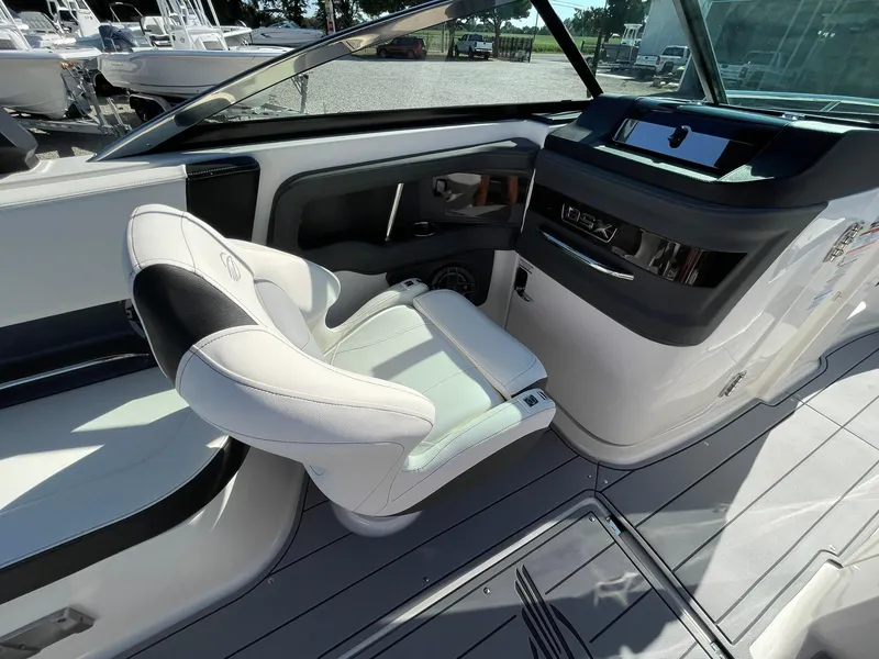 Slide: The Image of 2025 Chaparral 270 OSX boat interior with sleek dashboard and comfortable seating. - 38