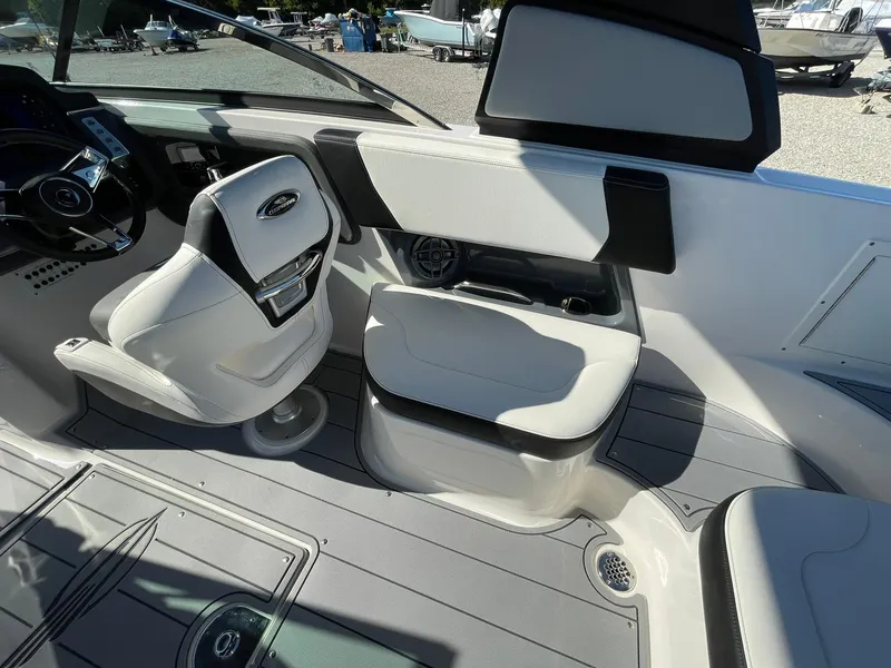 Slide: The Image of 2025 Chaparral 270 OSX boat interior with built-in storage and speaker system. - 48