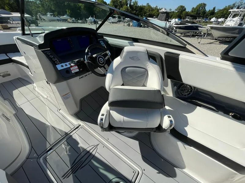 Slide: The Image of 2025 Chaparral 270 OSX boat cockpit with modern steering and seating. - 36