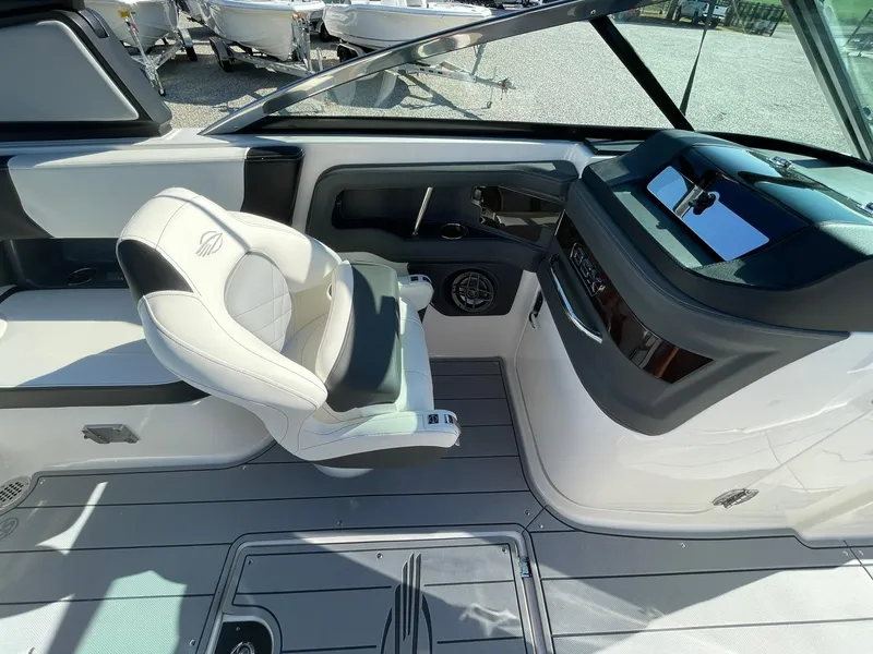 Slide: The Image of 2025 Chaparral 270 OSX boat interior with sleek dashboard and comfortable seating. - 38