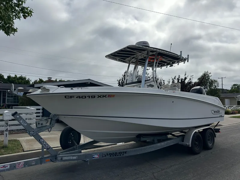 Slide: The Image of 2011 Boston Whaler 220 Outrage boat on trailer, parked on a residential street. - 13