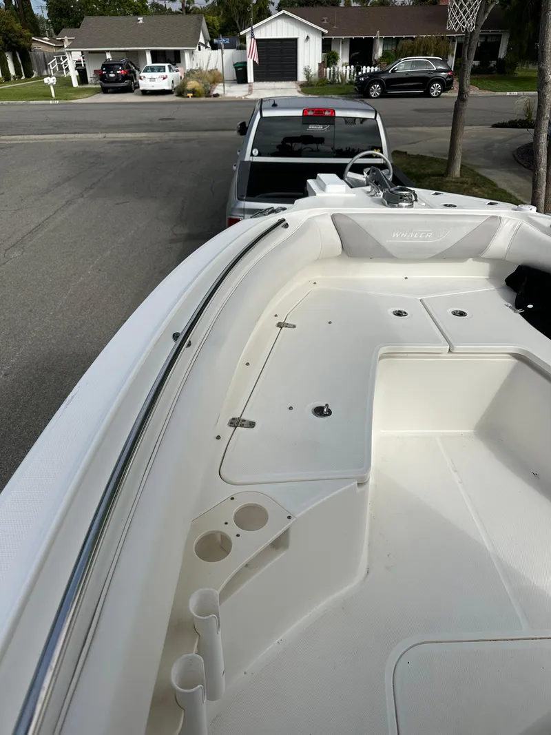 Slide: The Image of 2011 Boston Whaler 220 Outrage boat on trailer in suburban neighborhood. - 14