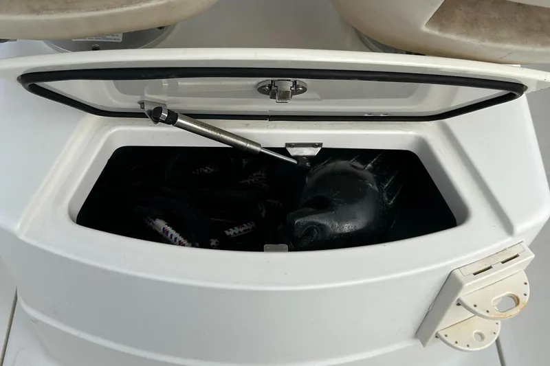 Slide: The Image of Open storage compartment on 2011 Boston Whaler 220 Outrage boat, showing interior contents. - 20