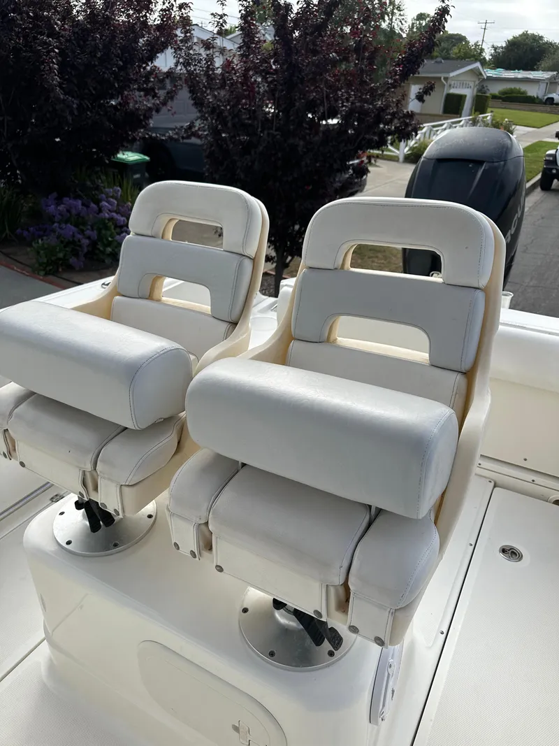 Slide: The Image of 2011 Boston Whaler 220 Outrage boat seats, white upholstery, outdoor setting. - 21