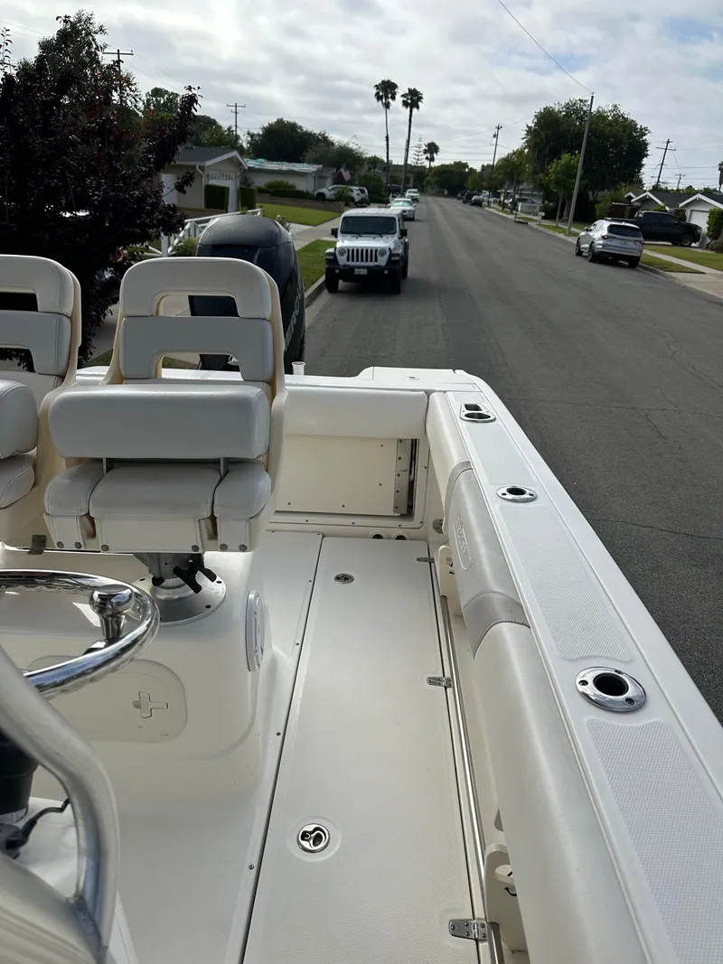 Slide: The Image of 2011 Boston Whaler 220 Outrage boat parked on a residential street. - 22