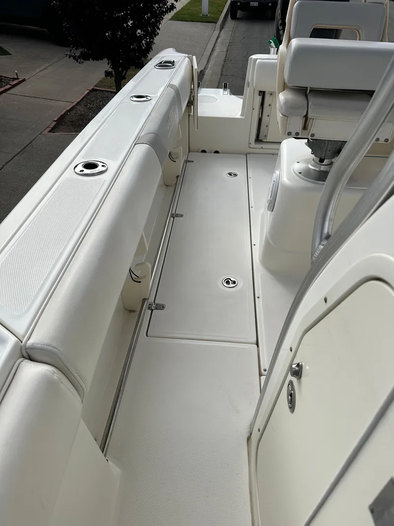 Slide: The Image of 2011 Boston Whaler 220 Outrage boat interior with white seating and deck. - 25