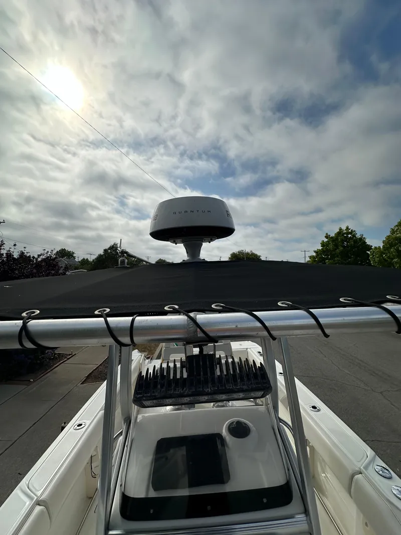 Slide: The Image of 2011 Boston Whaler 220 Outrage boat with radar, under cloudy sky. - 27