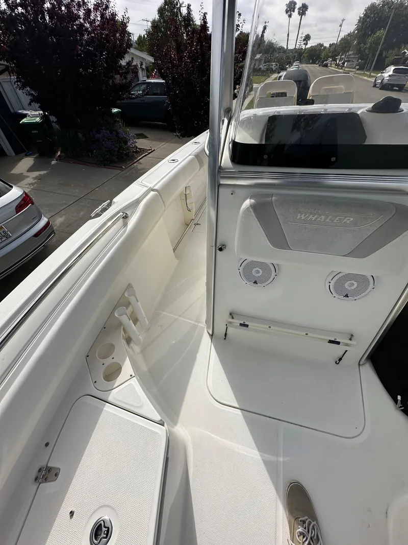 Slide: The Image of 2011 Boston Whaler 220 Outrage boat interior with seating and console details. - 29