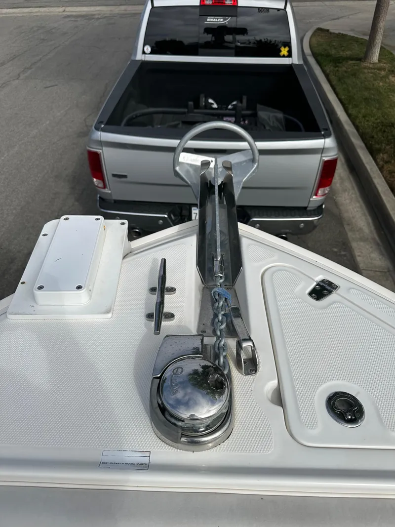Slide: The Image of 2011 Boston Whaler 220 Outrage boat hitched to a silver pickup truck. - 34