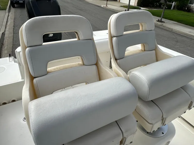 Slide: The Image of 2011 Boston Whaler 220 Outrage boat seats, white upholstery, street background. - 40