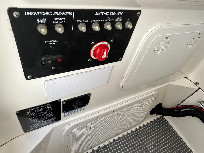 Slide: The Image of Control panel of a 2011 Boston Whaler 220 Outrage boat with switches and breakers. - 41