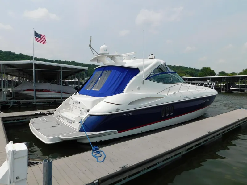 Slide: The Image of 2005 Cruisers Yachts 500 Express docked, featuring sleek design and vibrant blue accents. - 10