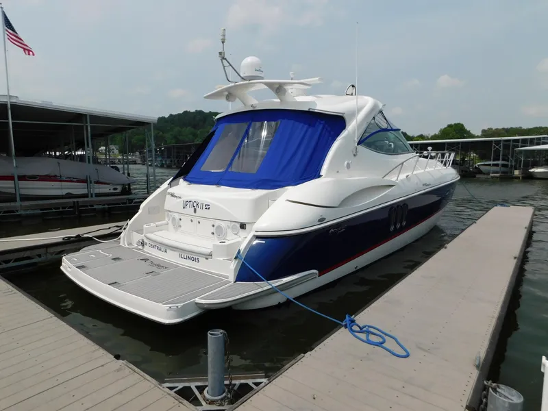 Slide: The Image of 2005 Cruisers Yachts 500 Express docked, featuring sleek design and blue accents. - 12