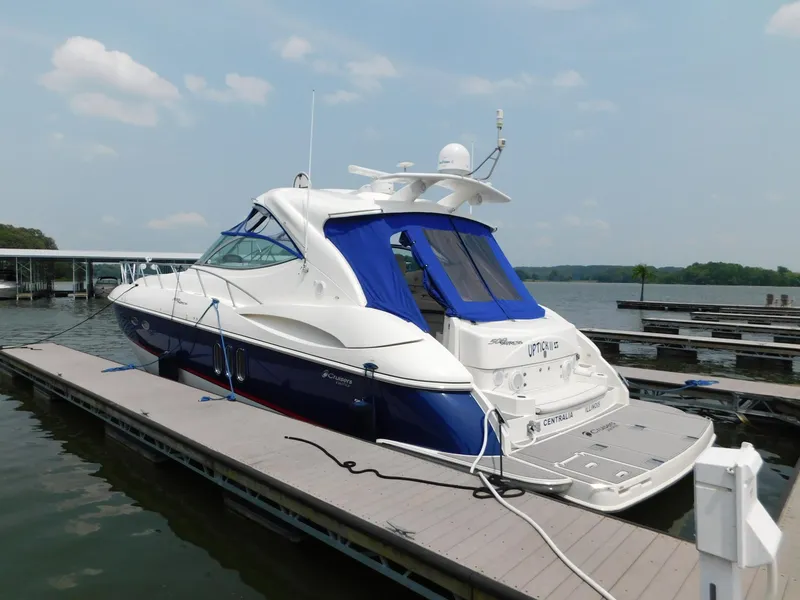 Slide: The Image of 2005 Cruisers Yachts 500 Express docked at marina, featuring sleek design and blue accents. - 15