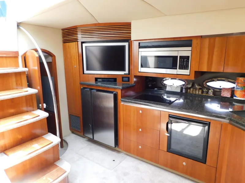Slide: The Image of Luxurious 2005 Cruisers Yachts 500 Express interior with modern kitchen and entertainment area. - 19