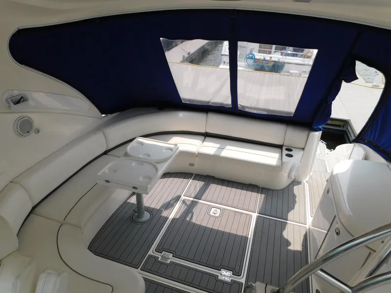 Slide: The Image of 2005 Cruisers Yachts 500 Express interior with white seating and blue canopy. - 21