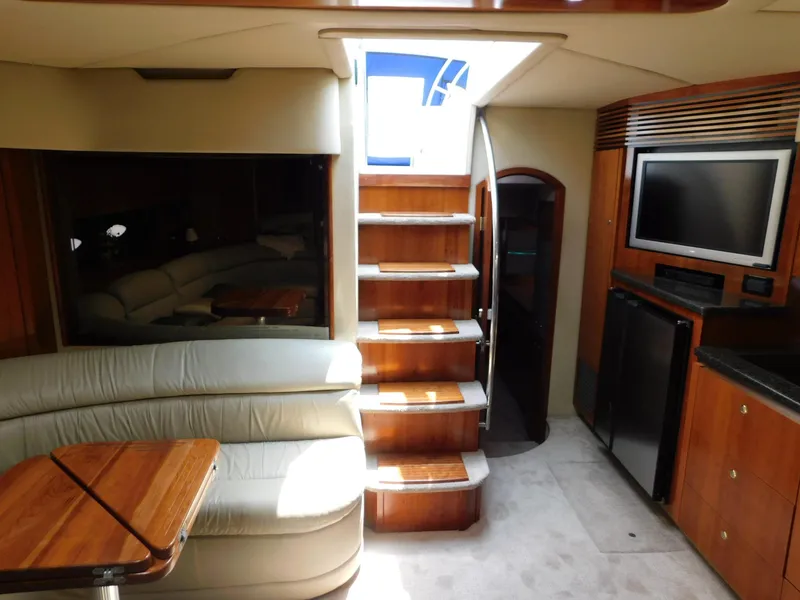 Slide: The Image of Interior of 2005 Cruisers Yachts 500 Express, featuring stairs, seating, and entertainment area. - 27