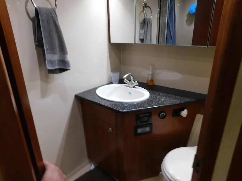 Slide: The Image of 2005 Cruisers Yachts 500 Express bathroom with sink, mirror, and towel. - 36