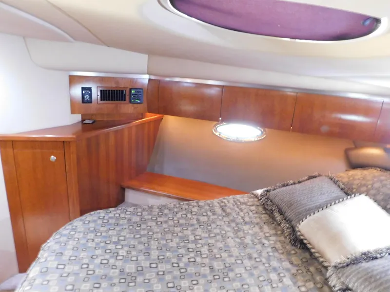 Slide: The Image of Luxurious cabin interior of 2005 Cruisers Yachts 500 Express with wood paneling and bedding. - 37