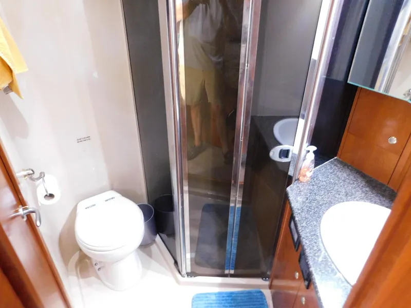 Slide: The Image of Bathroom interior of 2005 Cruisers Yachts 500 Express with shower, toilet, and sink. - 38