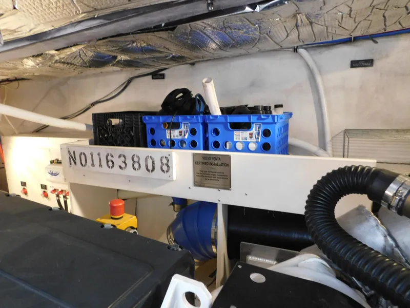 Slide: The Image of Engine room of 2005 Cruisers Yachts 500 Express with storage crates and equipment. - 47